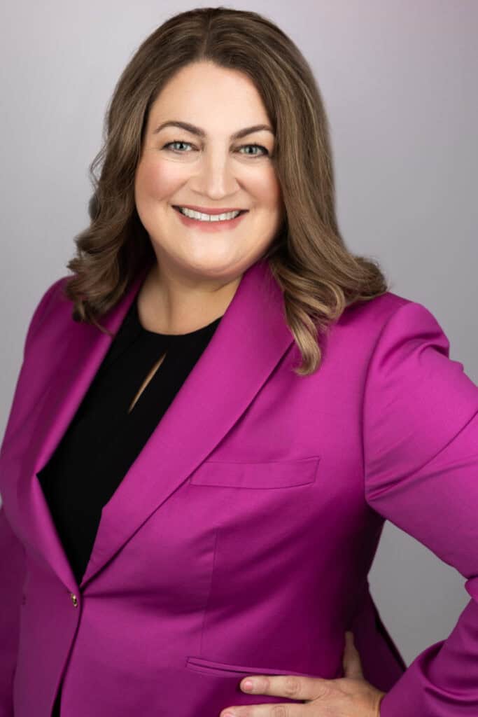Professional headshot of Jennifer Wright, an attorney, wearing a vibrant pink blazer.